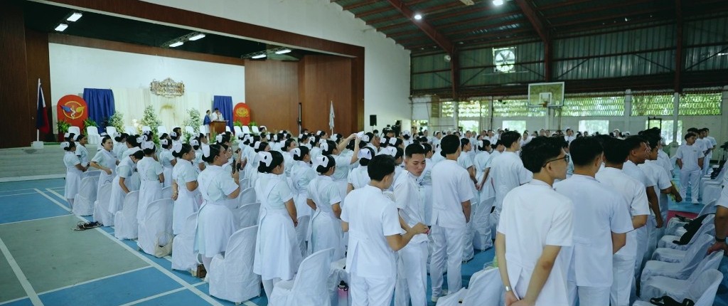 Nadeleine and Alleviare students stand together in the gymnasium before the program