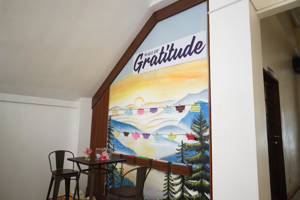 The Wall of Gratitude mural under the CPAC library, with notes of thanksgiving clipped across a painted mountain landscape