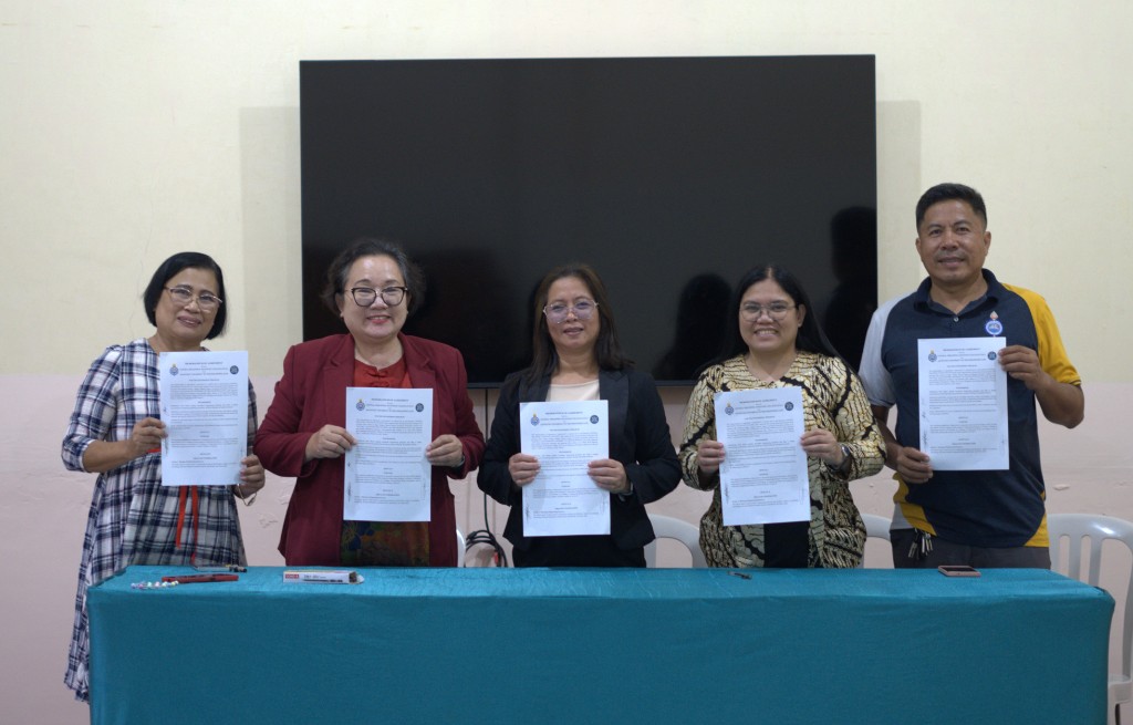 CPAC and partner university representatives display the signed Memoranda of Agreement after the signing ceremony